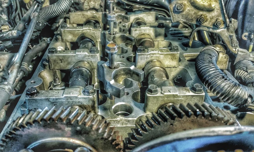 An opened engine exposing the camshafts with the cam sprockets exposed